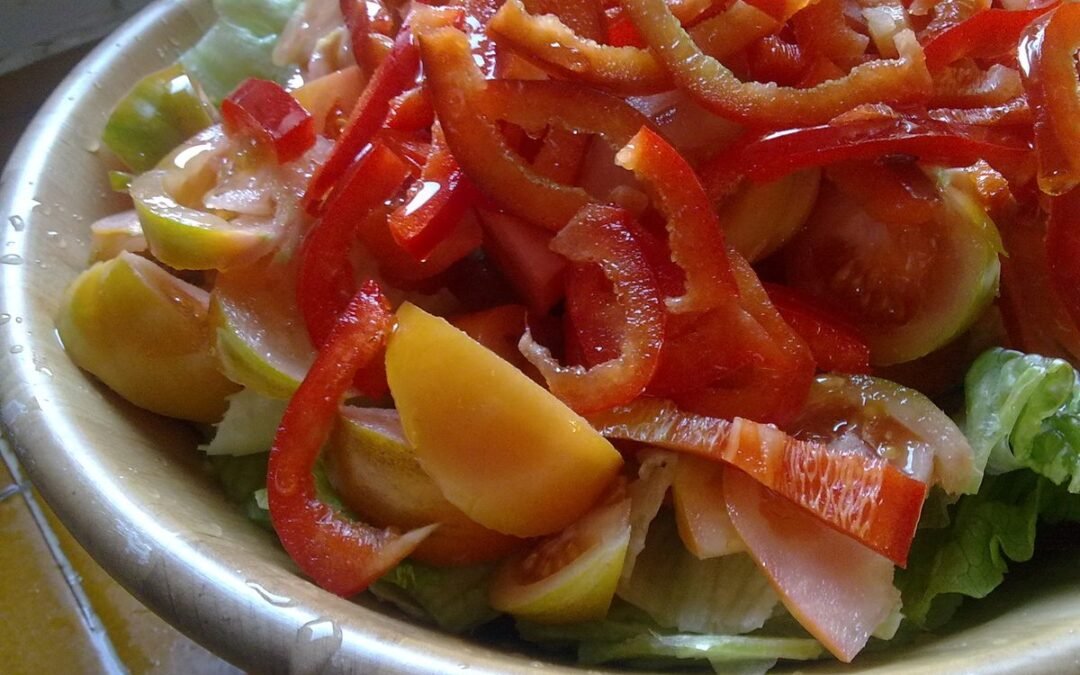 Bowl of salad with red pepper strips, yellow vegetables and lettuce for a Mediterranean inflammation detox program